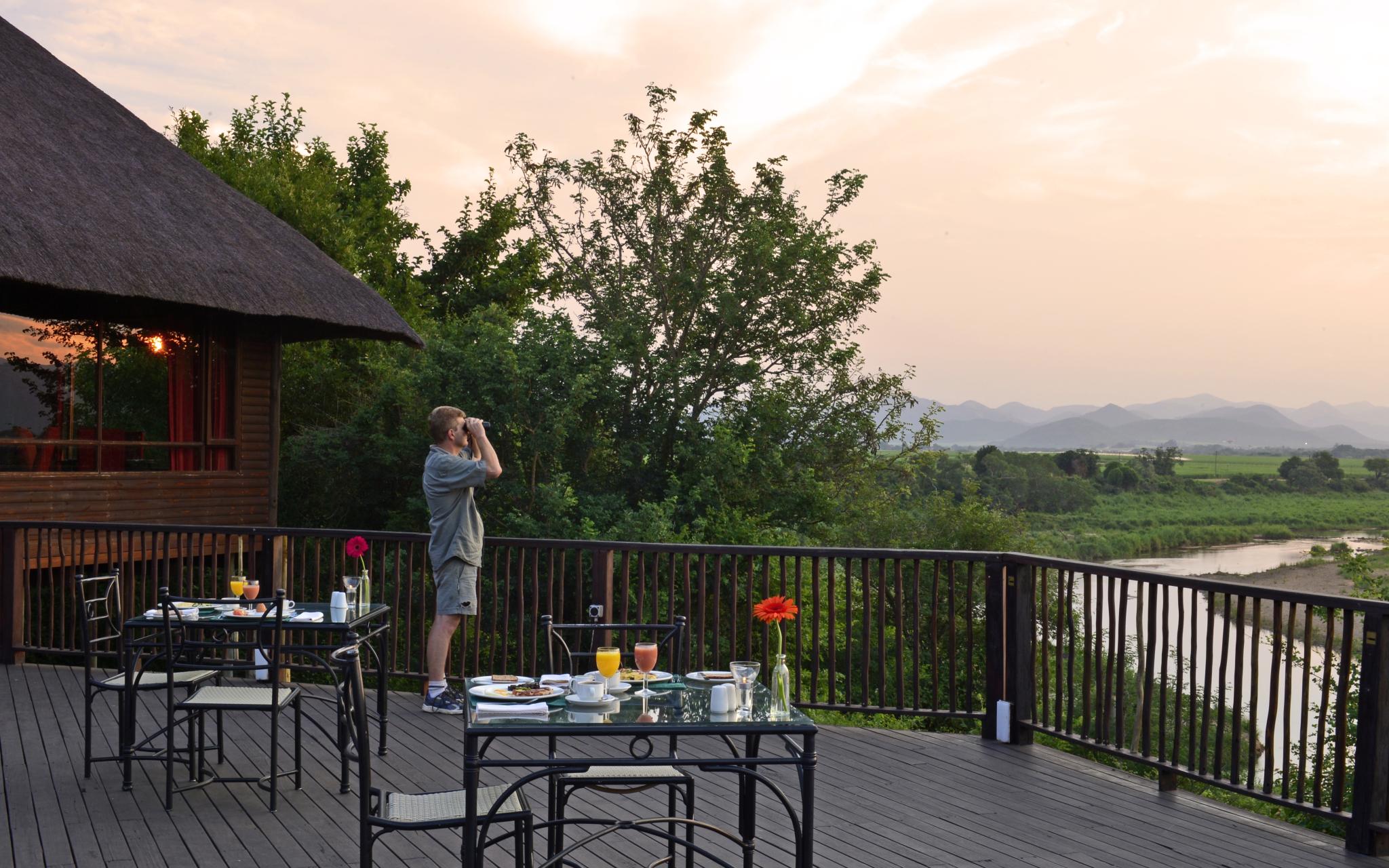 Pestana Kruger Lodge, 4-star hotel in Kruger Park, with tables on the balcony for meals while watching wildlife