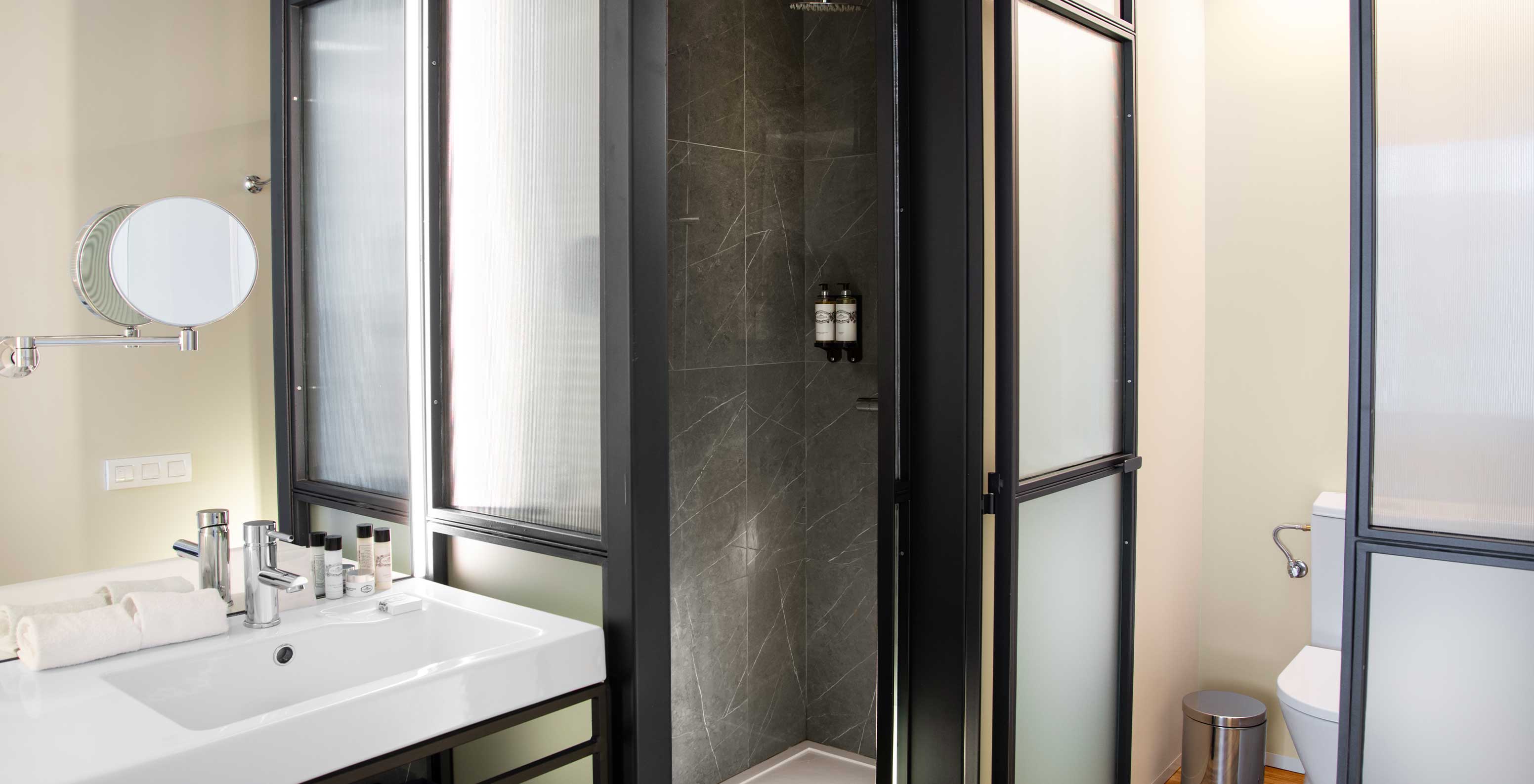 The Superior Plaza Mayor at Pestana Plaza Mayor Madrid has bathroom with washbasin, mirror, shower, towels