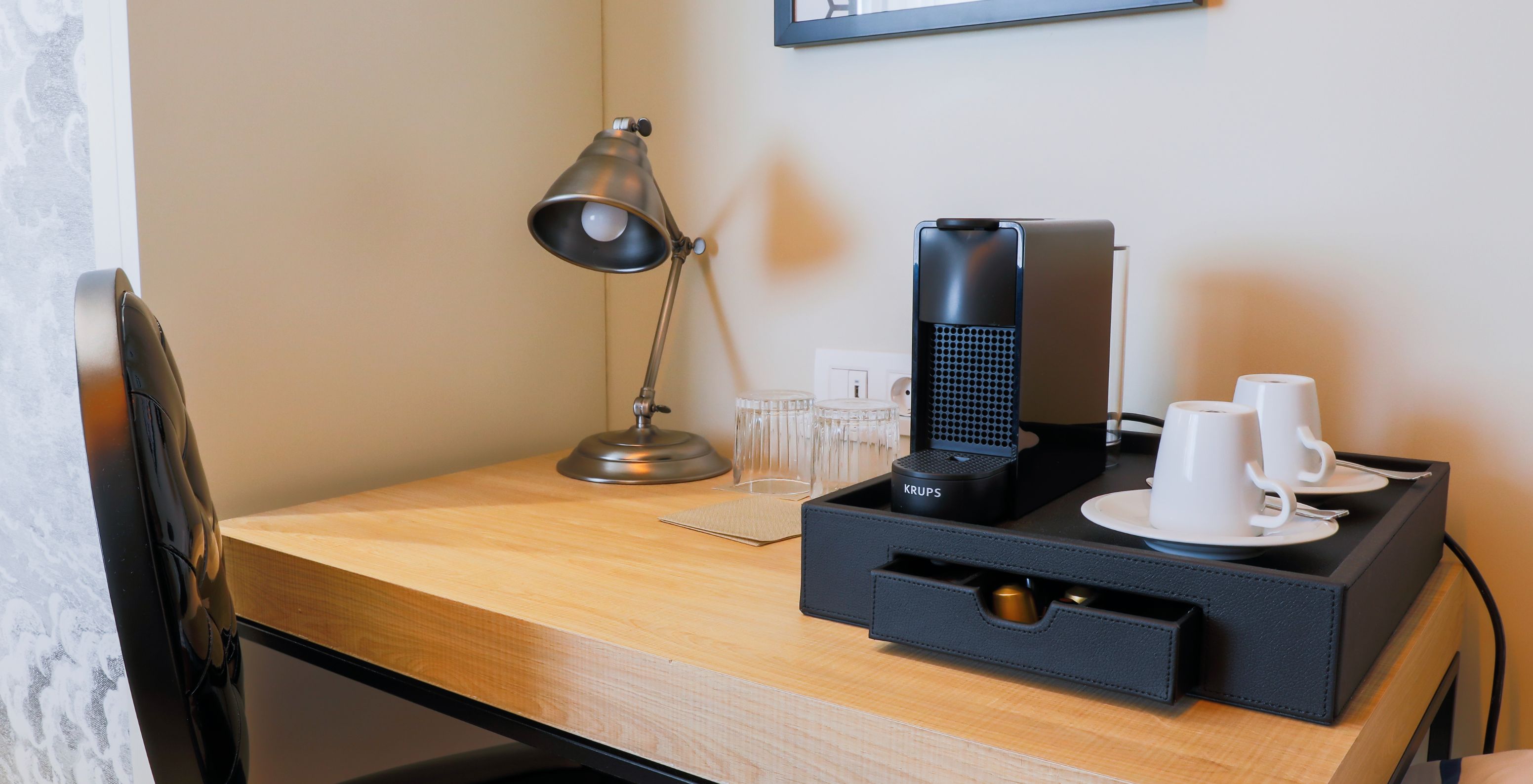 The Superior Plus Room at Pestana Collection Plaza Mayor has a coffee station with a machine and coffee cups.