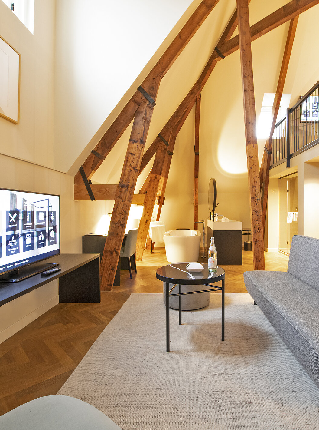 Clock Tower Suite at Pestana Amsterdam Riverside has a living room with sofa, coffee table, and TV