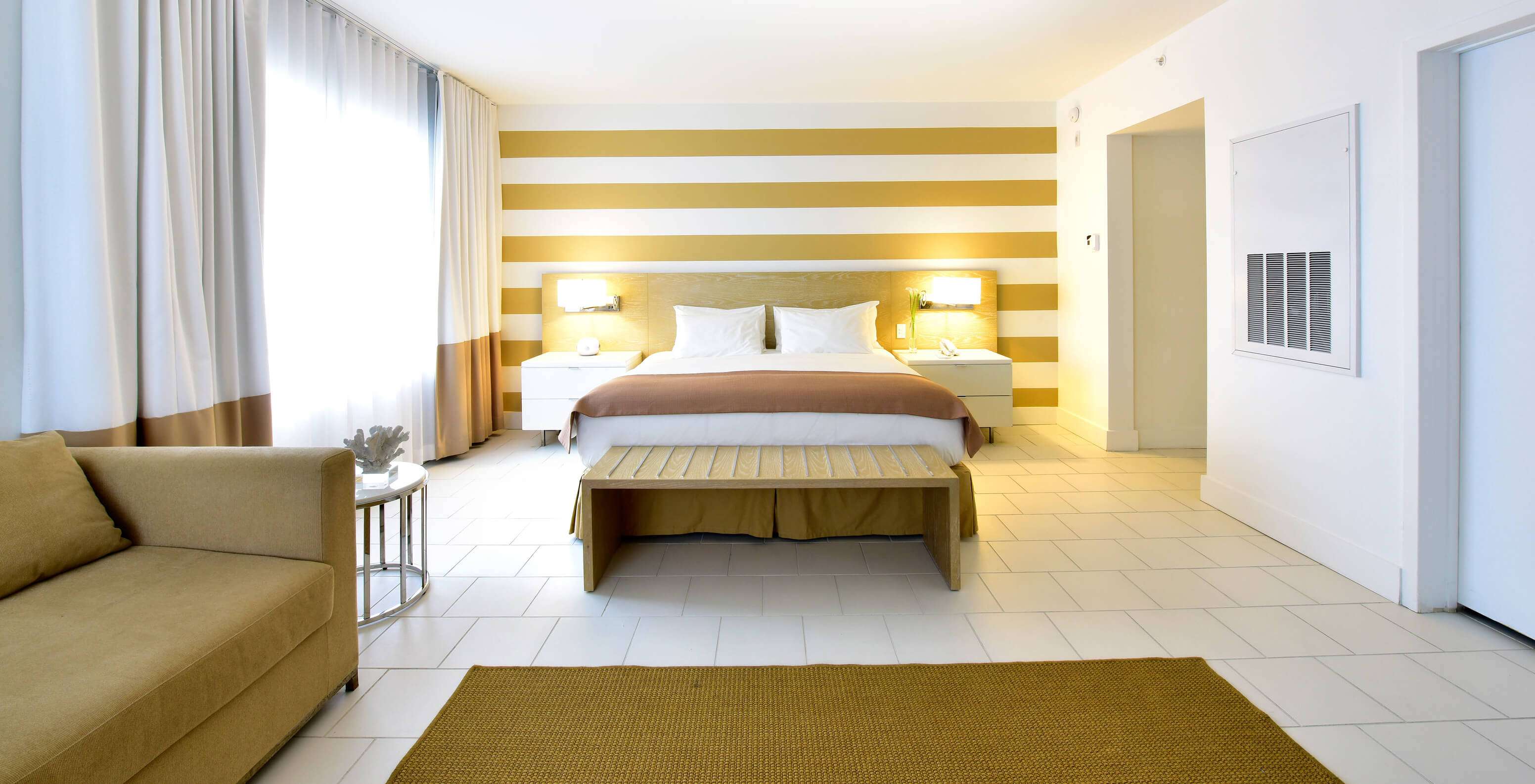 The Deluxe with Sofa Bed at Pestana Miami South Beach has a double bed, bedside table and lamp