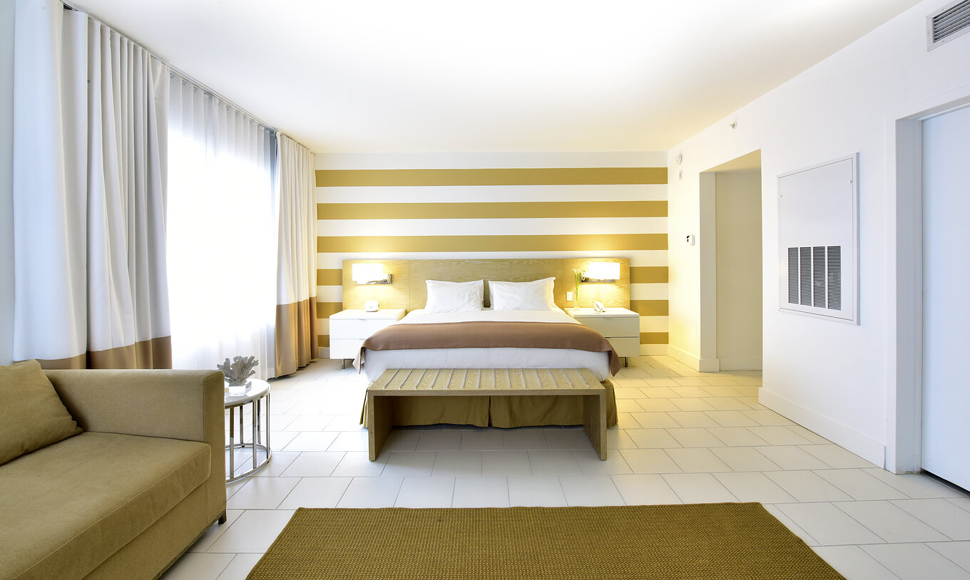 The Deluxe with Sofa Bed at Pestana Miami South Beach has a double bed, bedside table and lamp
