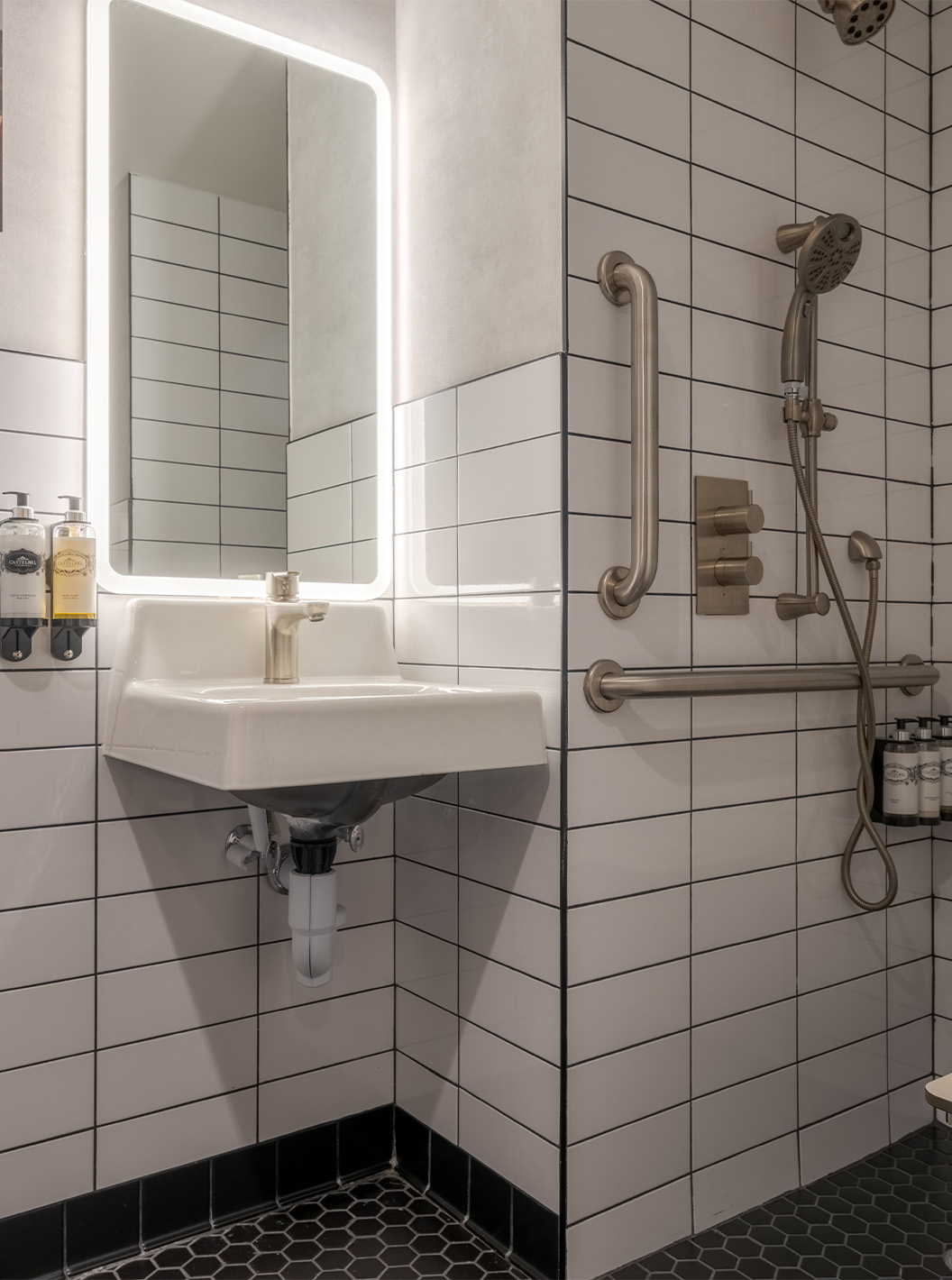 The Comfort Double ADA at Pestana CR7 Times Square has an adapted bathroom with shower, sink, and mirror