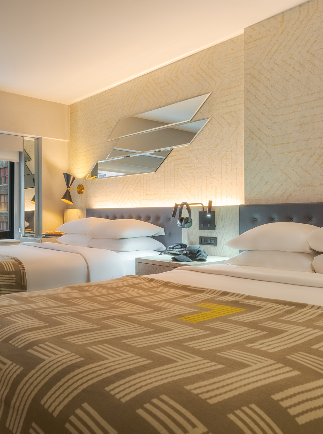 The Comfort Double at Pestana CR7 Times Square has two beds with a bedspread with the number seven and a window