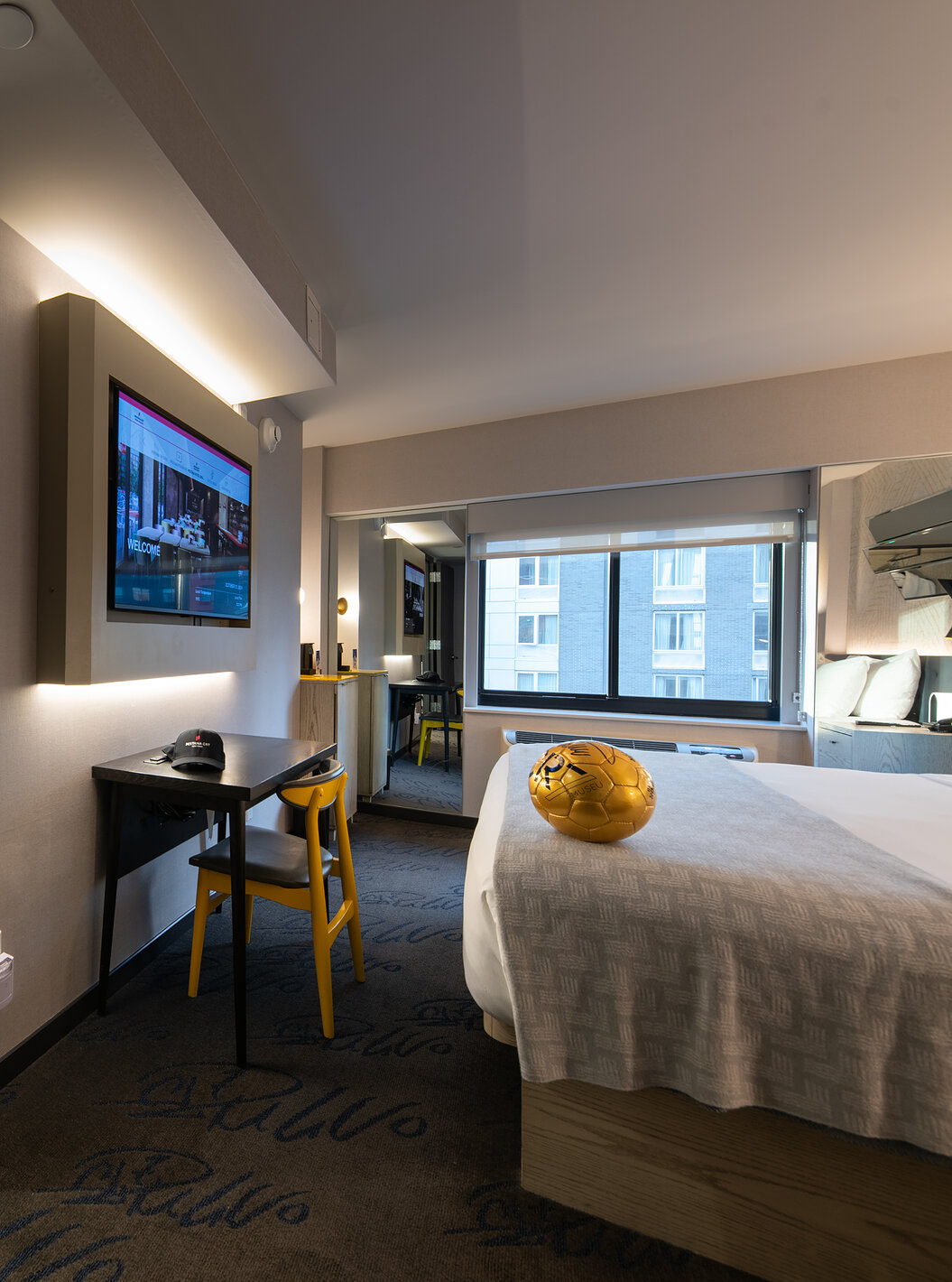 The Deluxe King Room at Pestana CR7 Times Square has a bathroom next to the room with a sink