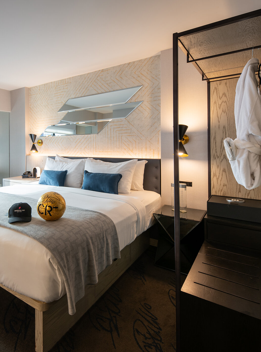 The Deluxe King Room at Pestana CR7 Times Square has a double bed, window, and wardrobe
