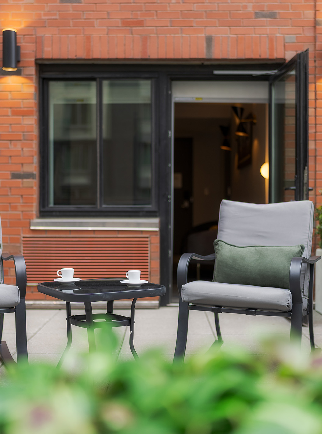 The ADA Junior Suite with Balcony and View at Pestana CR7 Times Square has a balcony with two chairs and a table