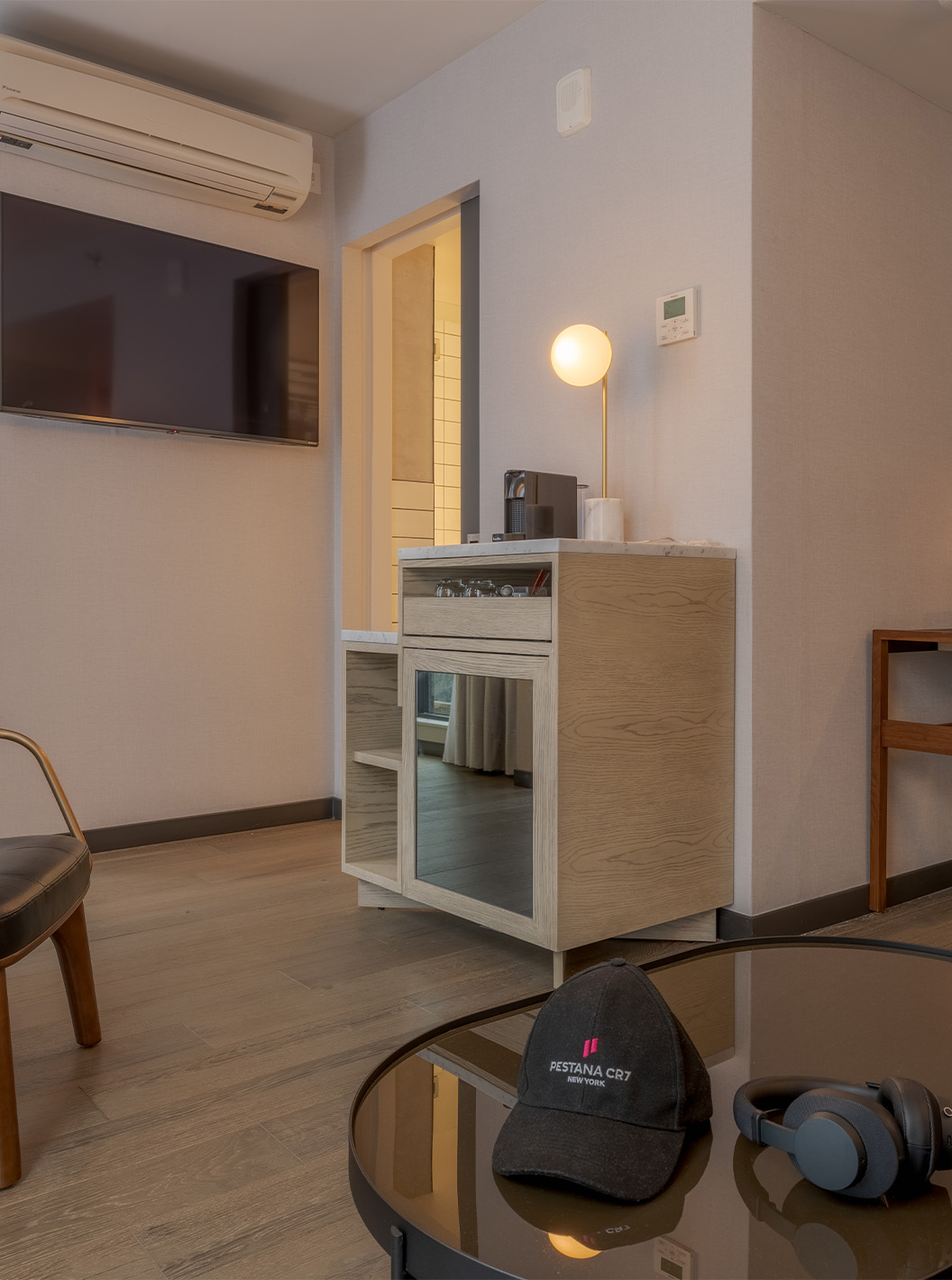The Junior Suite with Balcony and View at Pestana CR7 Times Square has a desk, an armchair, and a coffee machine