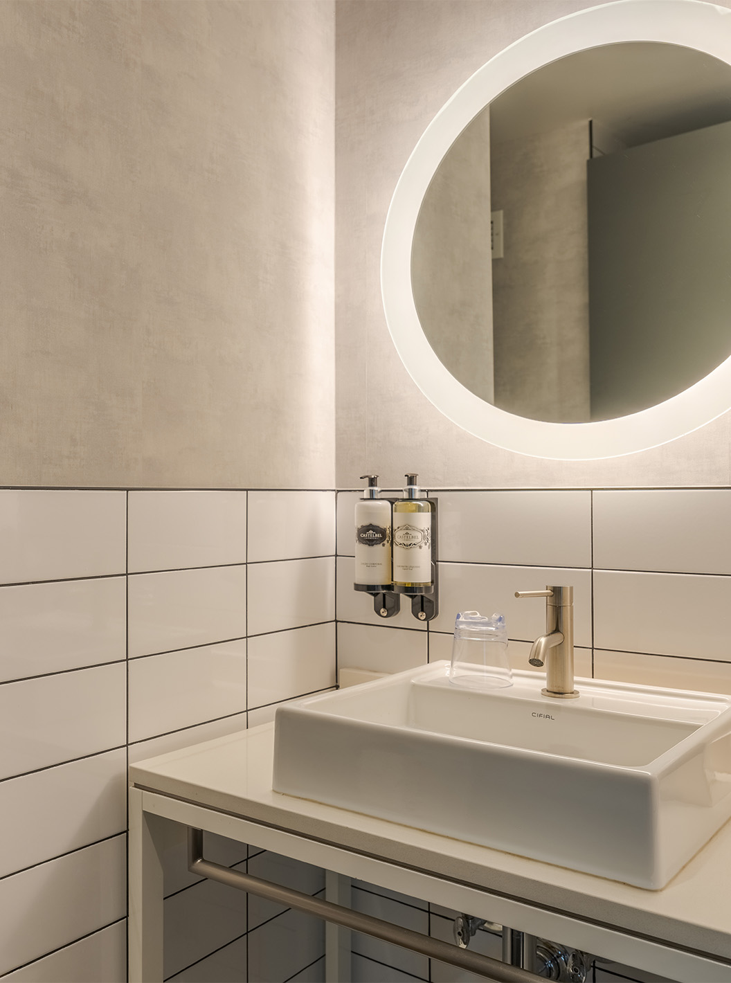 The Superior Double at Pestana CR7 Times Square has a bathroom with sink and a round mirror with lights around