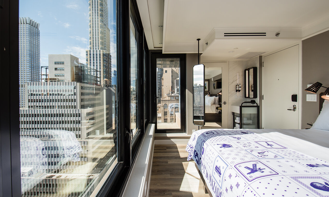 The Balcony room at Pestana Park Avenue has a double bed, a mirror, and a panoramic view of the city