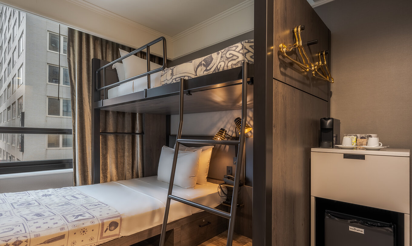 The Cabin room at Pestana Park Avenue has a bunk bed with two single beds, a fridge and a coffee machine