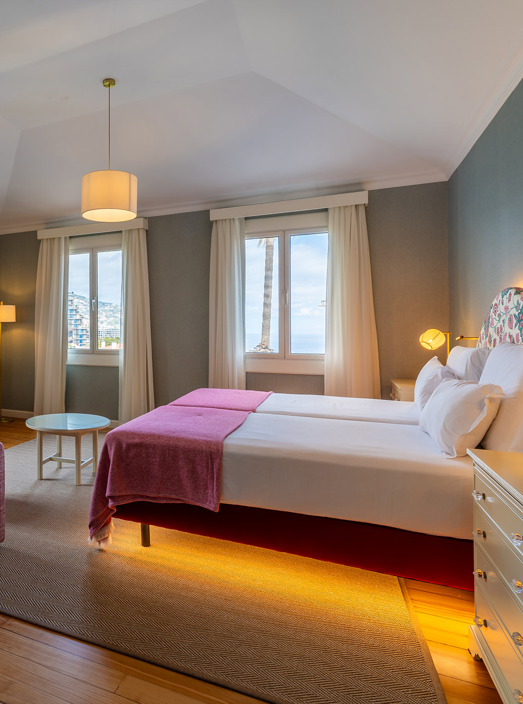 The Junior Suite Partial Sea View Room at Pestana Quinta Perestrello has a double bed, a sofa, and a television.