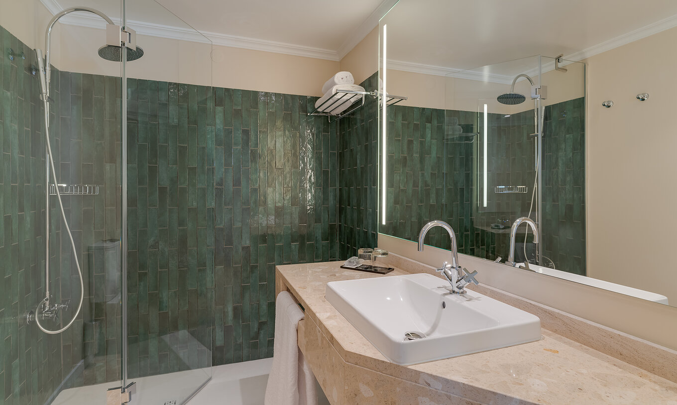 Junior Suite at Pestana Quinta Perestrello has a bathroom with sink, mirror, towels, and shower