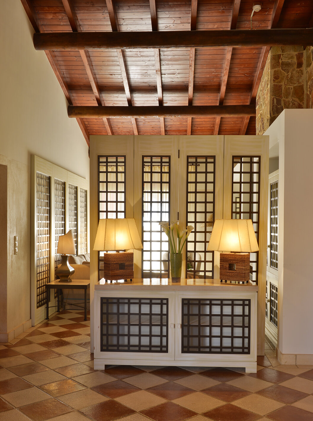 La Suite Vista Jardín Vila Sol del Pestana Vila Sol - Vilamoura tiene una entrada con una mesa, dos lámparas y una jarra