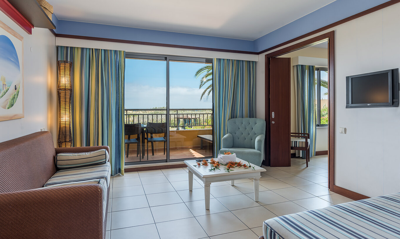 La Suite Apartamento T1 del Pestana Porto Santo All Inclusive tiene una sala con acceso al balcón, con vista al jardín