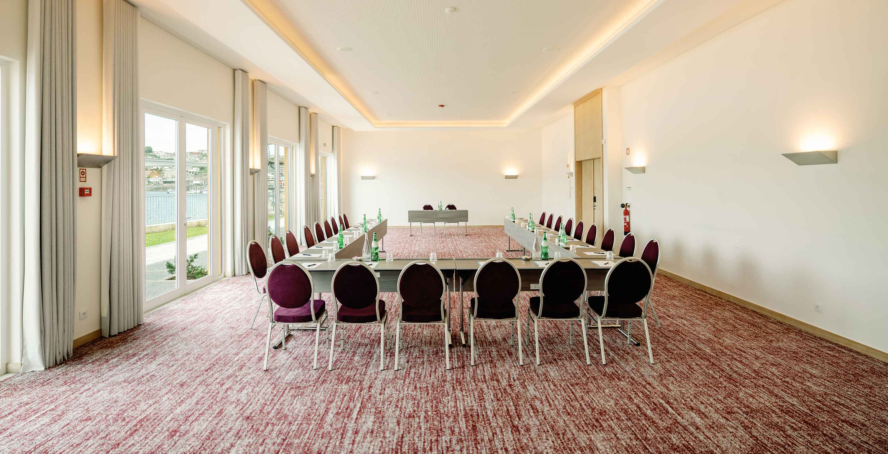 Sala Douro III con mesas en forma de U en el Pestana Douro Riverside Hotel con piscina frente al río Duero