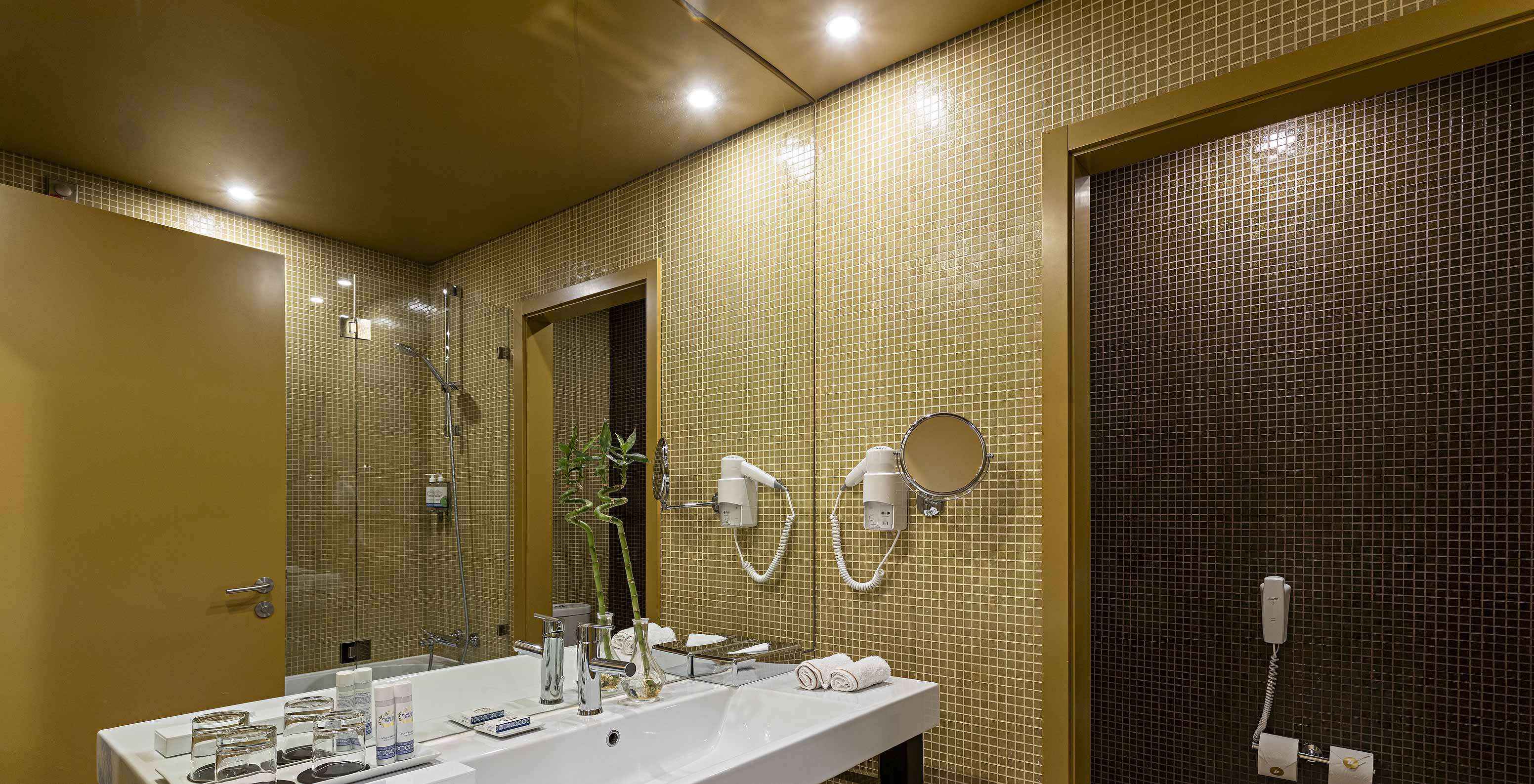 El Executive tiene un baño con azulejos amarillos y marrones