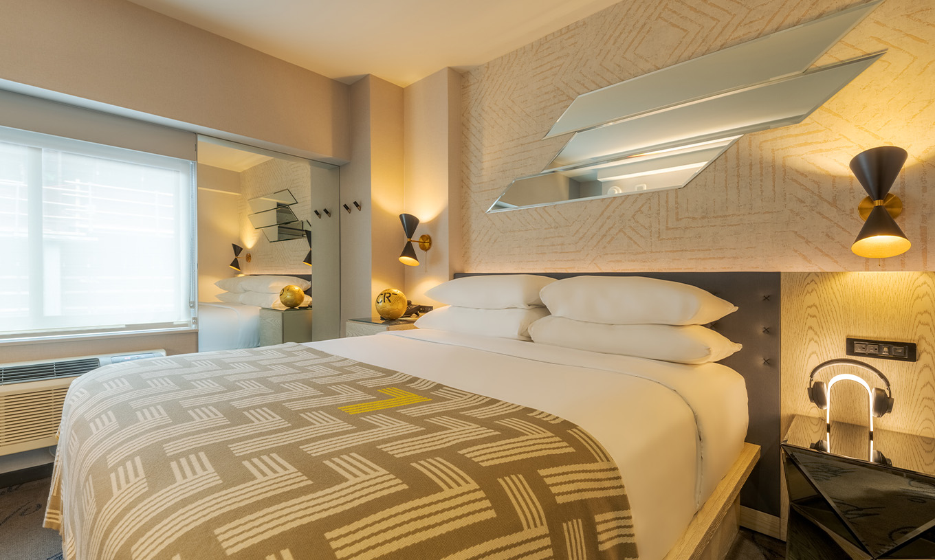 Comfort Room at Pestana CR7 Times Square has a double bed with a bedspread with the number seven and a window
