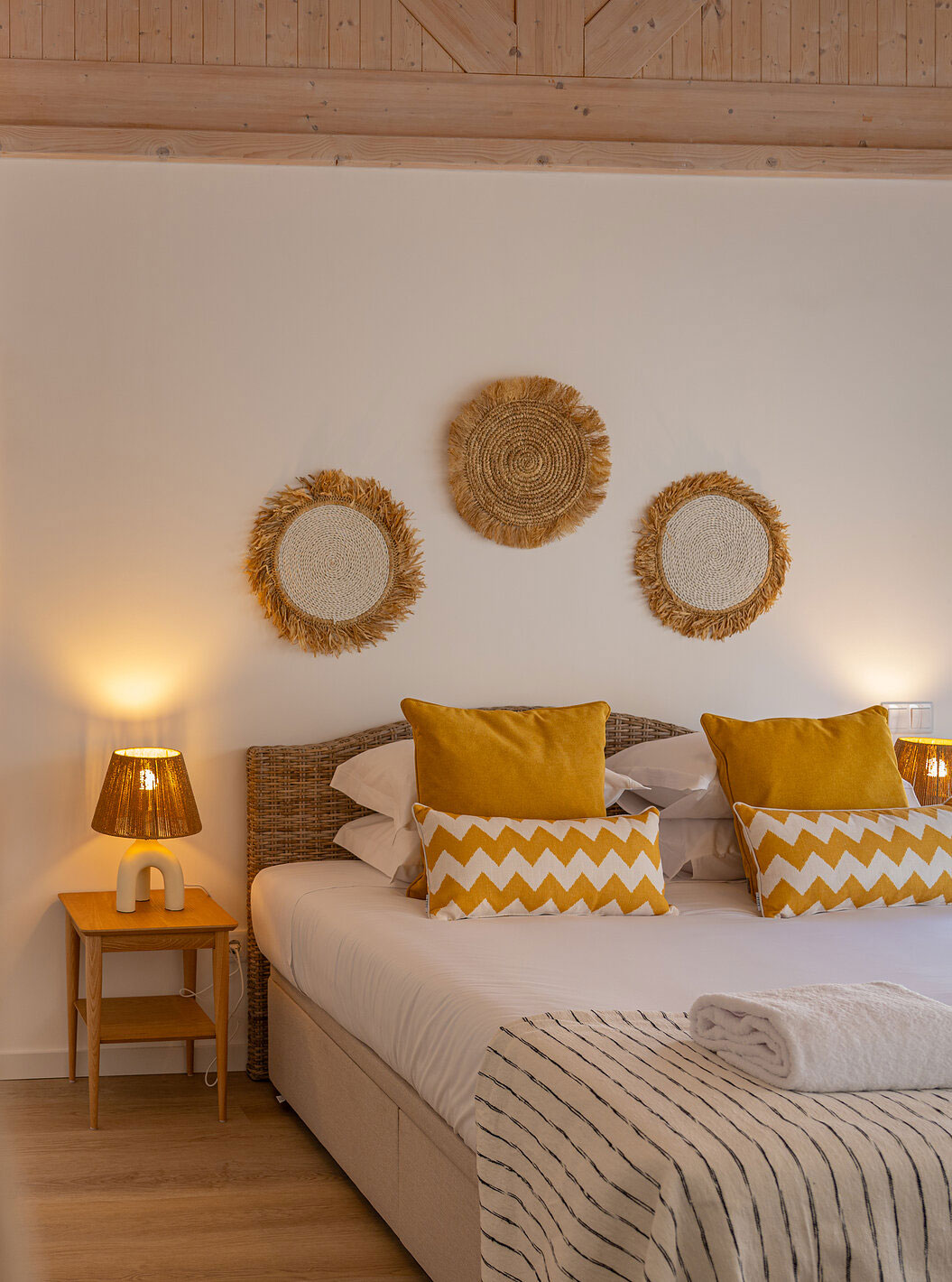 A Superior Villa do Pestana Comporta Village Residences tem um quarto com uma cama de casal e almofadas amarelas