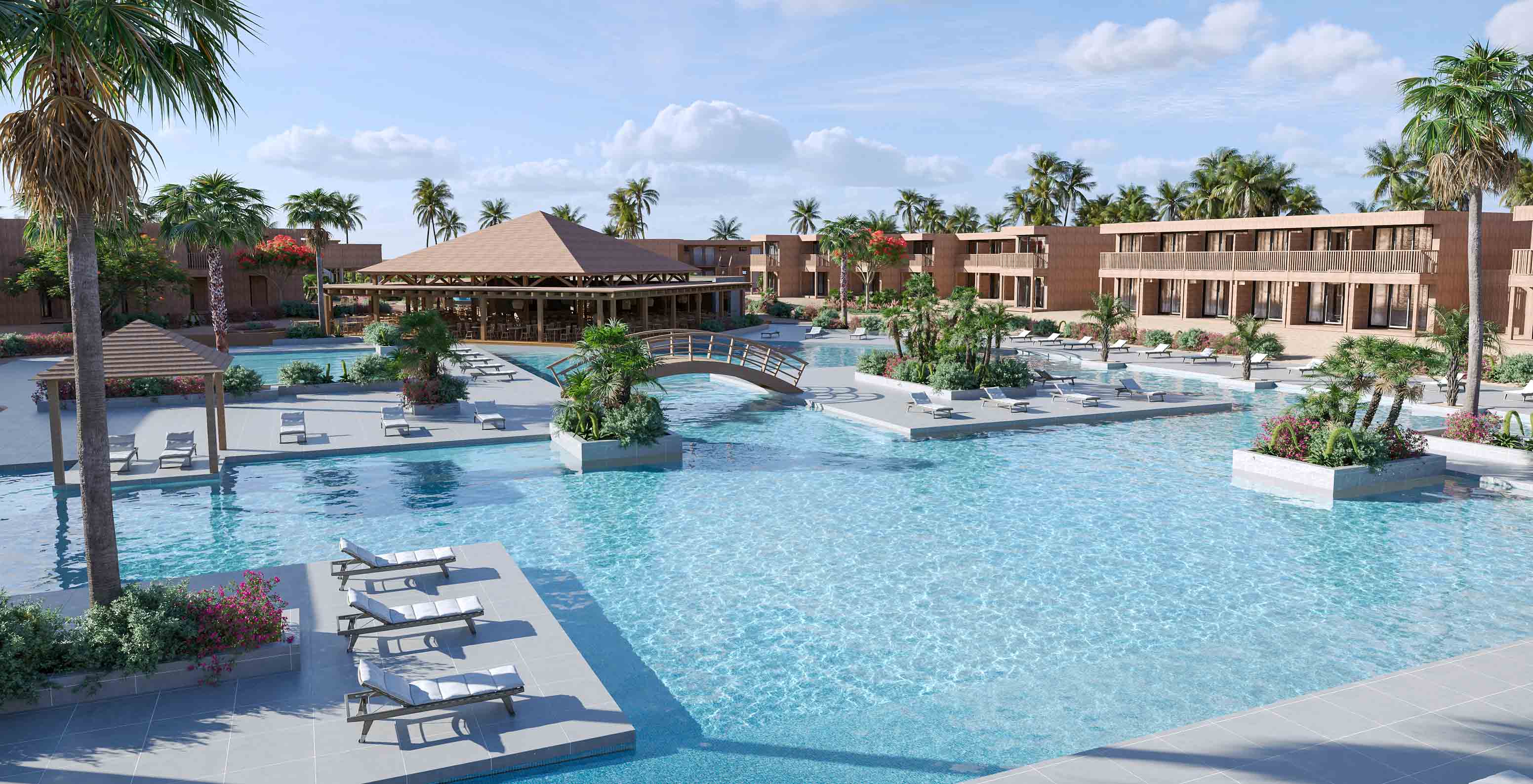 Piscina e jardins do hotel Pestana Dunas Porto Santo, com espreguiçadeiras, palmeiras e ponte de madeira sobre a água