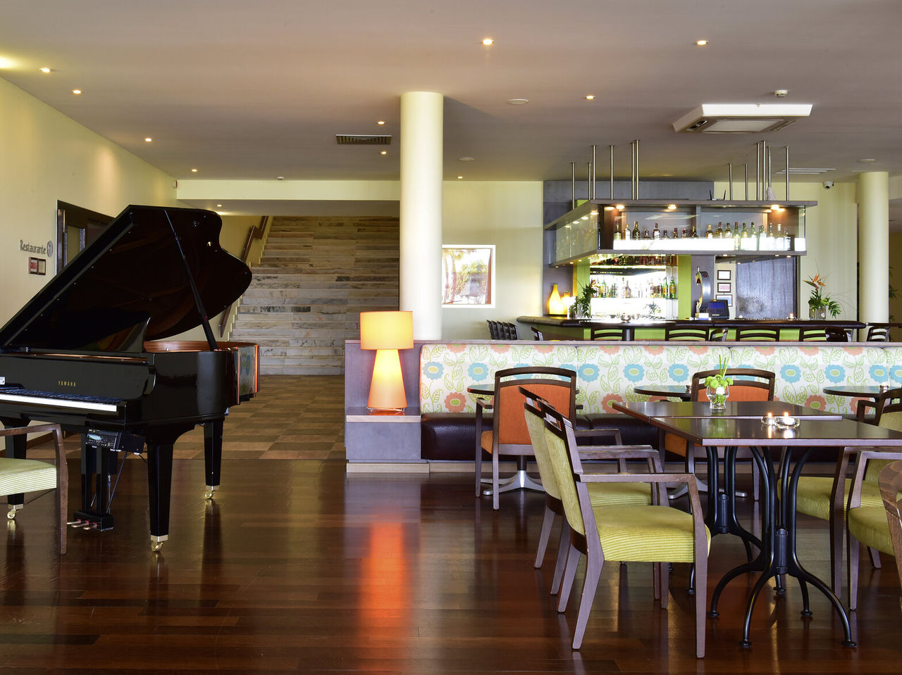De Tapas Bar, van het 4-sterrenhotel in Alvor, heeft tafels en stoelen, een piano en een bar voor drankjes