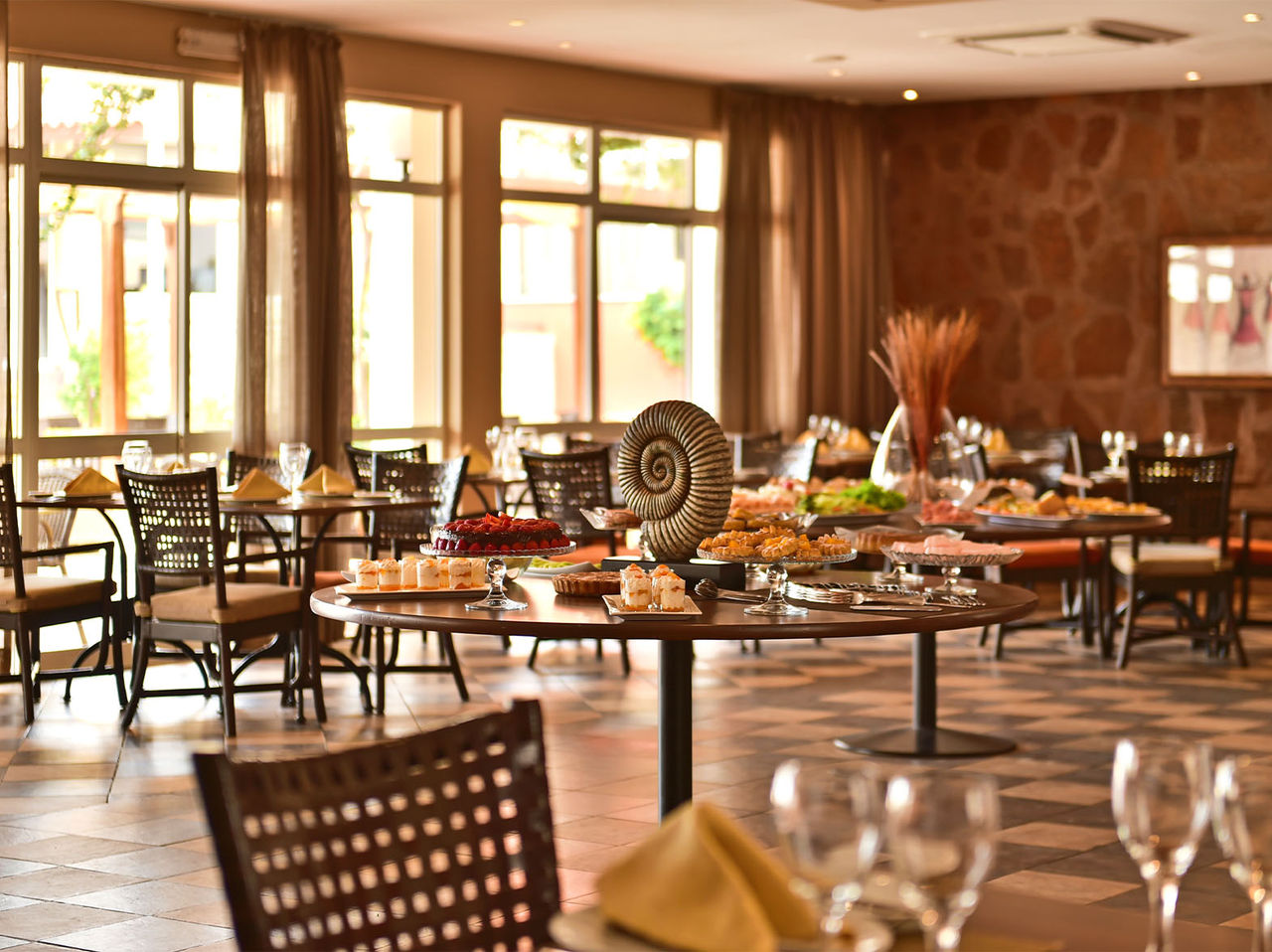 The Creole restaurant, at the 4-Star Hotel in Cape Verde, offers a spacious area with chairs and a variety of dishes