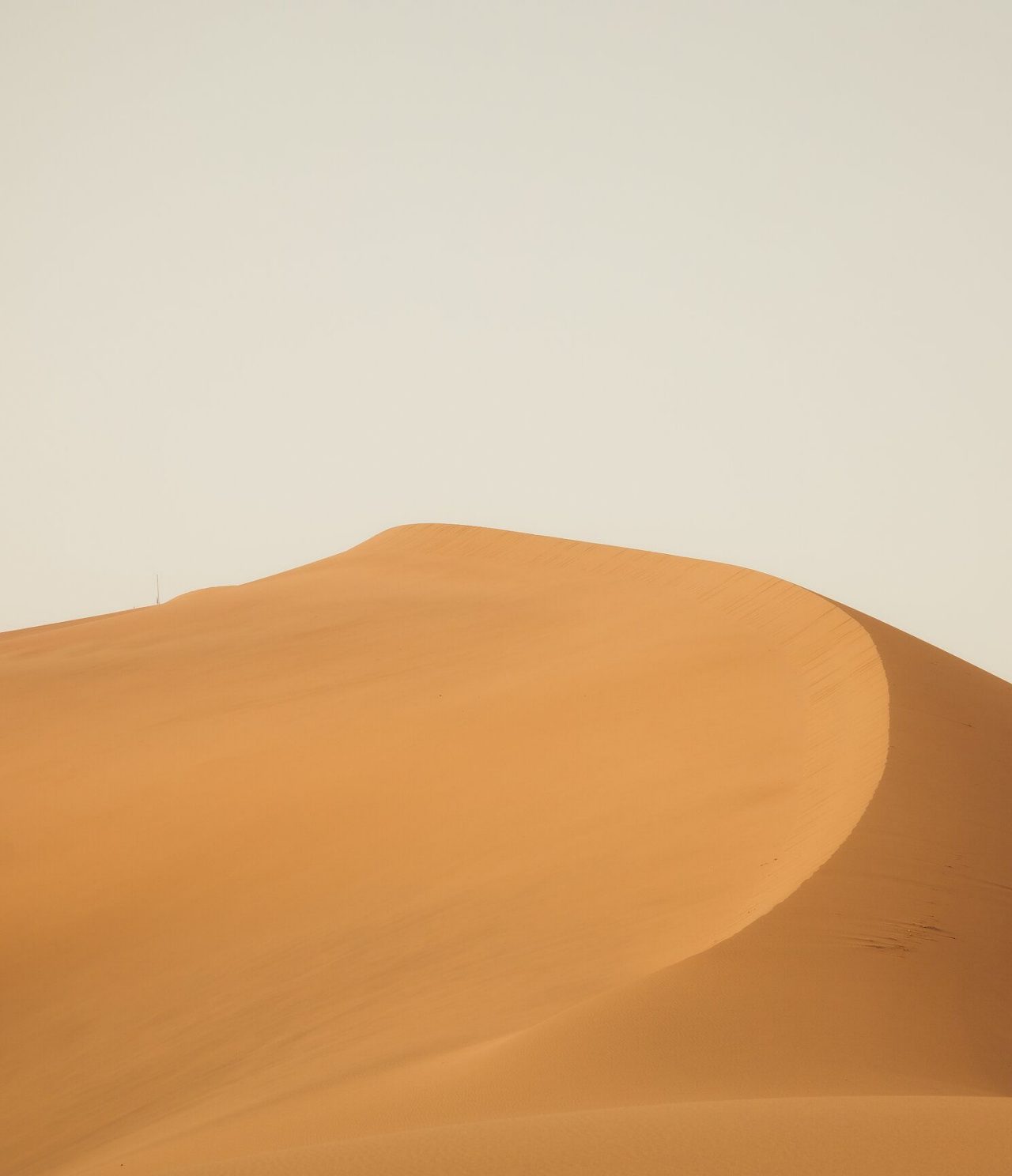 Large sand dune in the desert near Marrakech under a cloudy sky