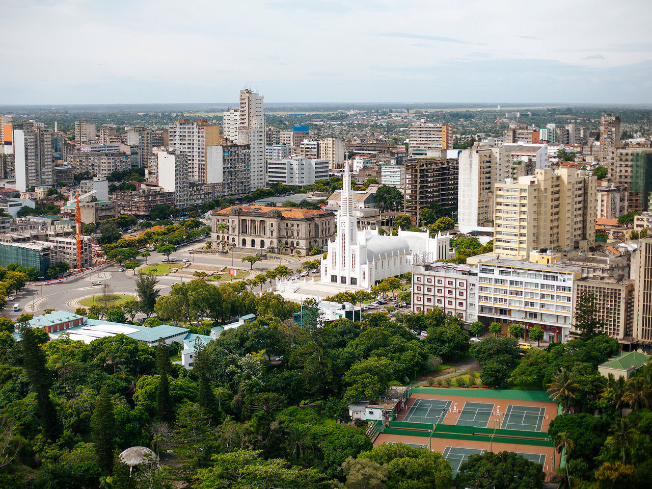View over the cosmopolitan city of Maputo, capital of Mozambique, with several buildings, a cathedral, and green spaces