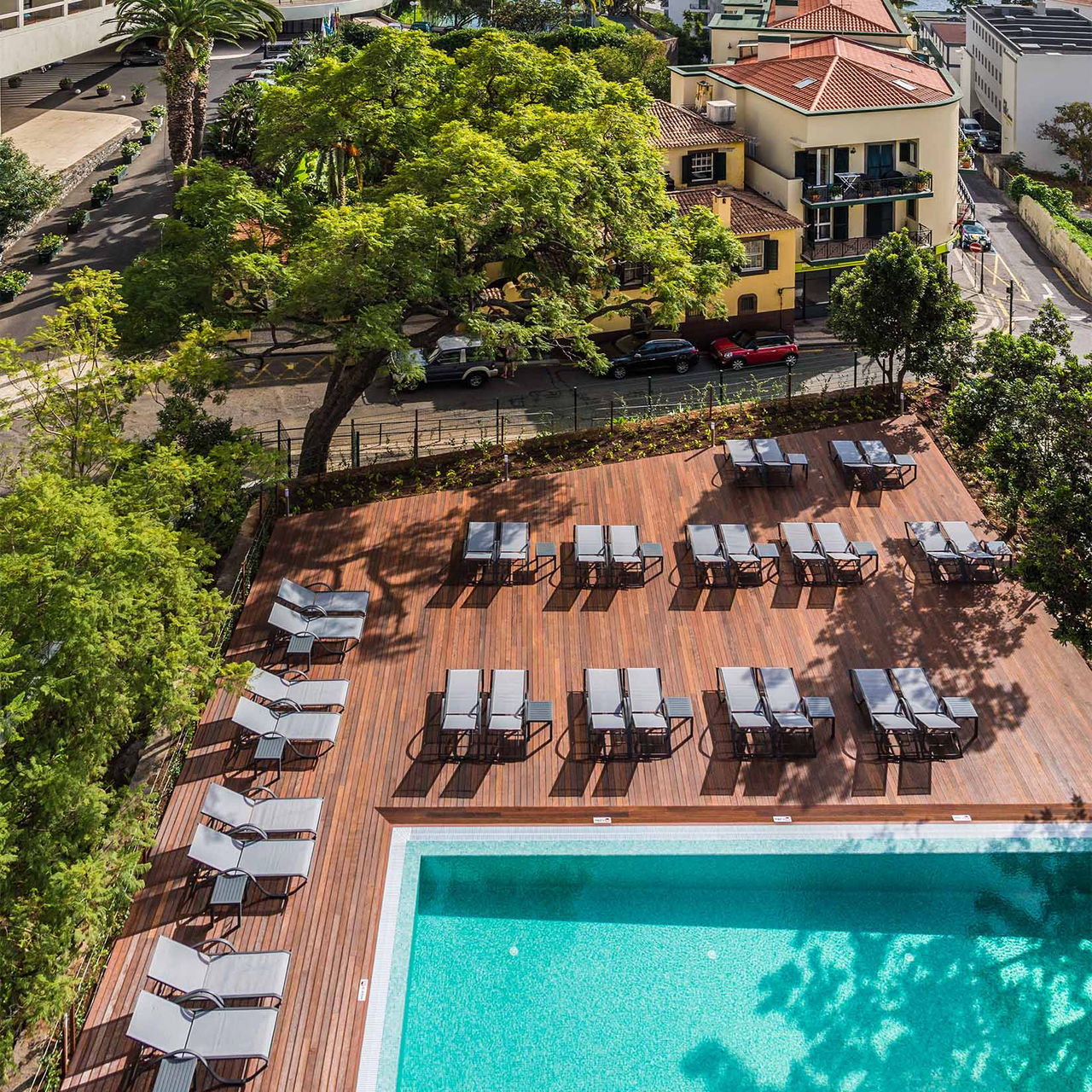 Aerial view of the pool at Pestana Casino Studios, with apartments in the city center, with loungers