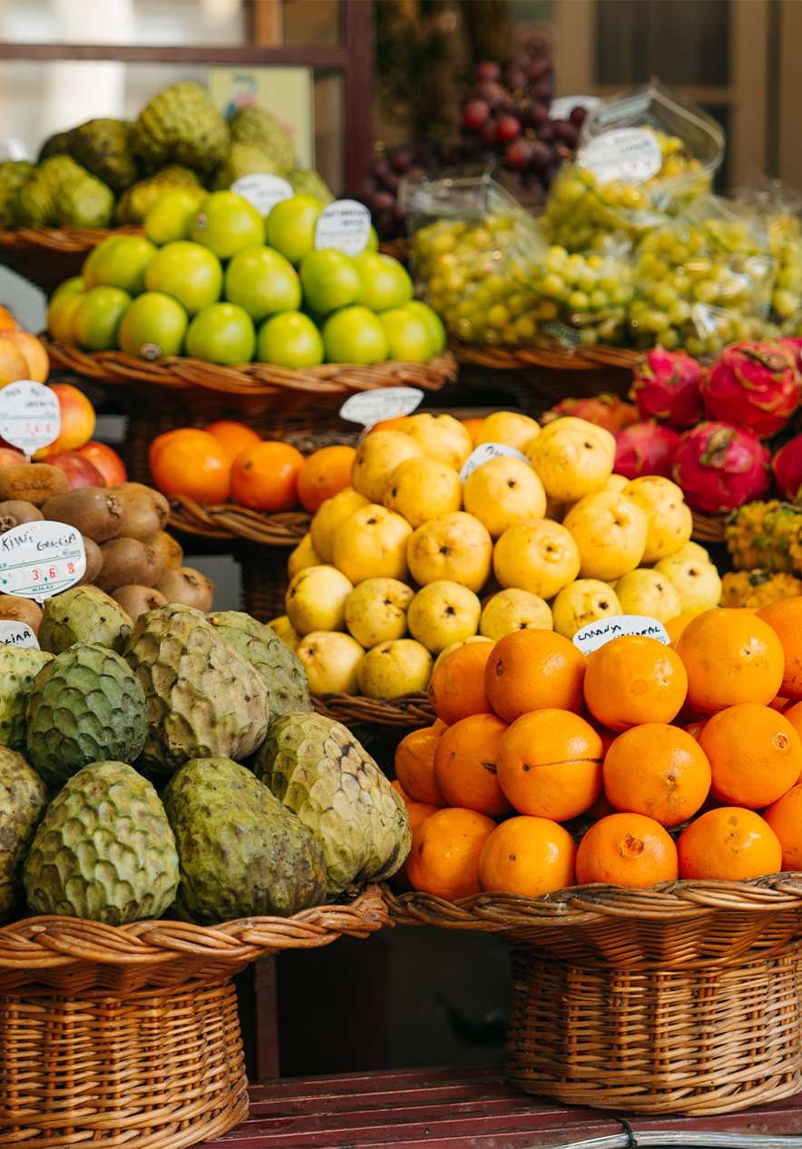 Baskets with colorful tropical fruits at the Farmer's Market in the historic center of Funchal