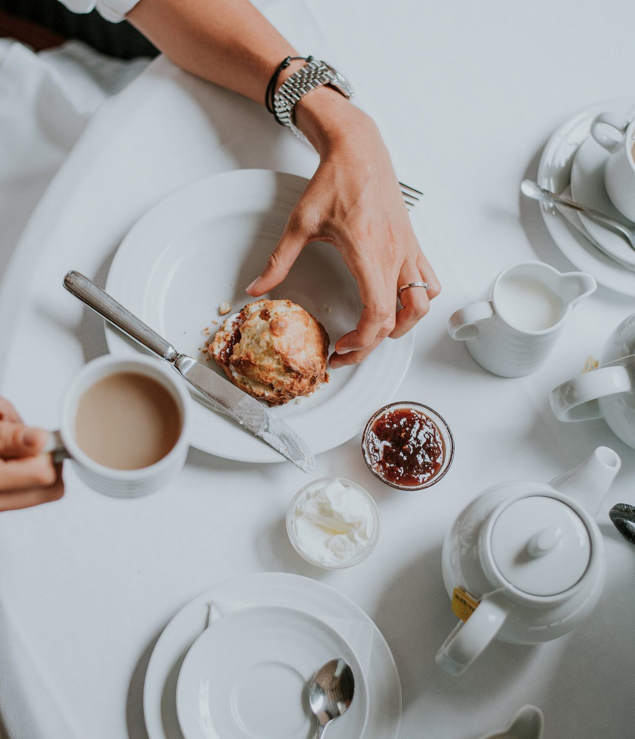 The restaurant A Vila, of the Romantic Hotel in Funchal, Madeira, has a table with coffee, a scone, and jam