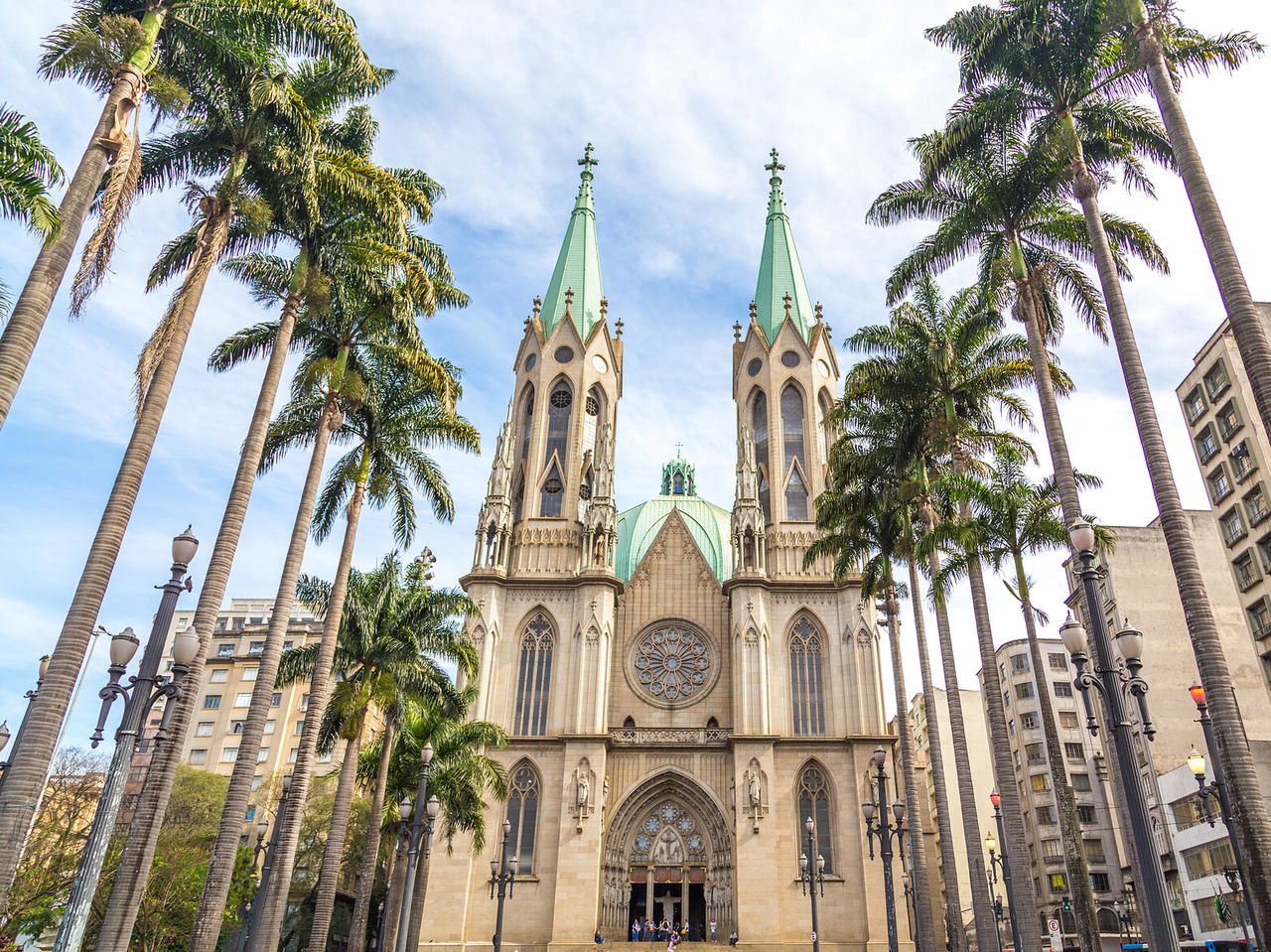 Cathedral of São Paulo, with its characteristic towers, surrounded by palm trees